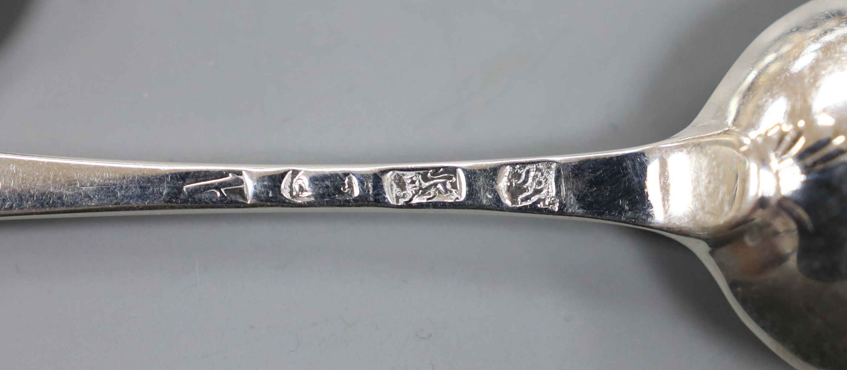 A set of six 18th century silver Old English pattern dessert spoons, indistinct marks, maker SW, possibly London, 1737, 16.5cm, 154 grams.